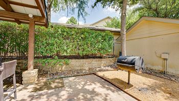 Patio with a grill and a table